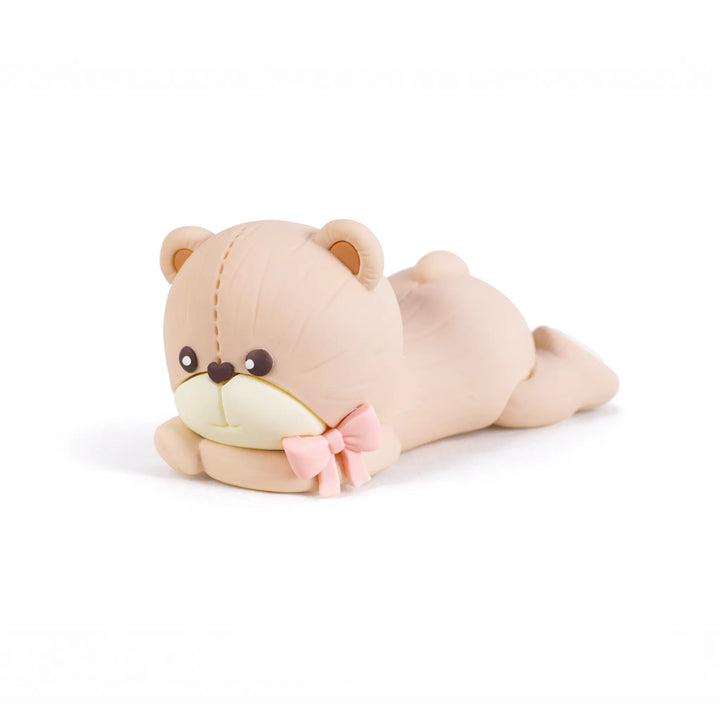 Pink bow teddy bear laying on stomach cake topper
