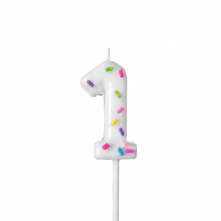 White number 1 birthday candle with colorful sprinkles