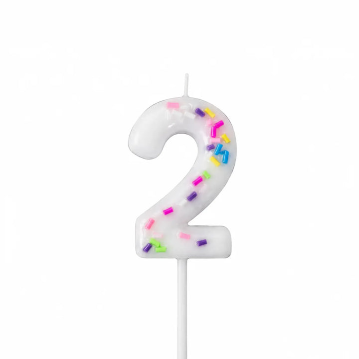 White number 2 birthday candle with colorful sprinkles