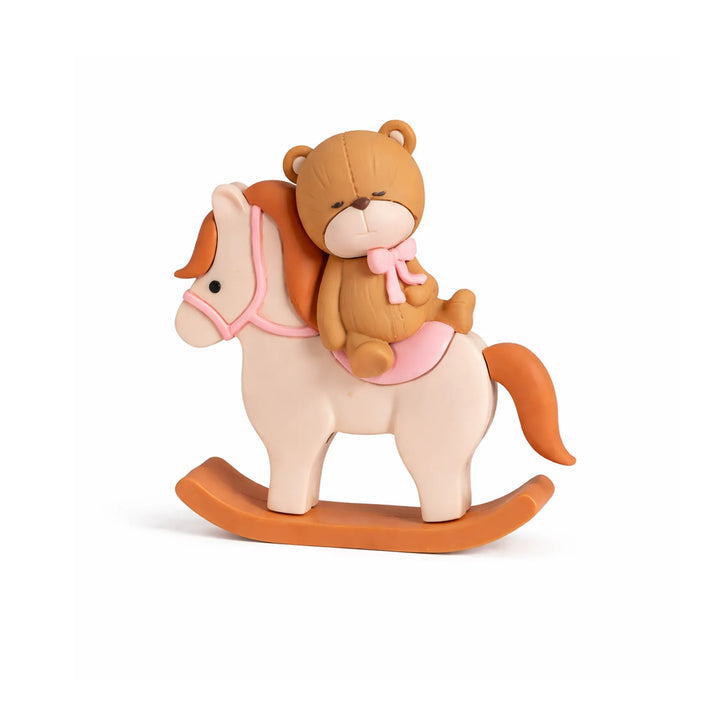 Sleeping teddy bear on rocking horse cake topper with pink saddle